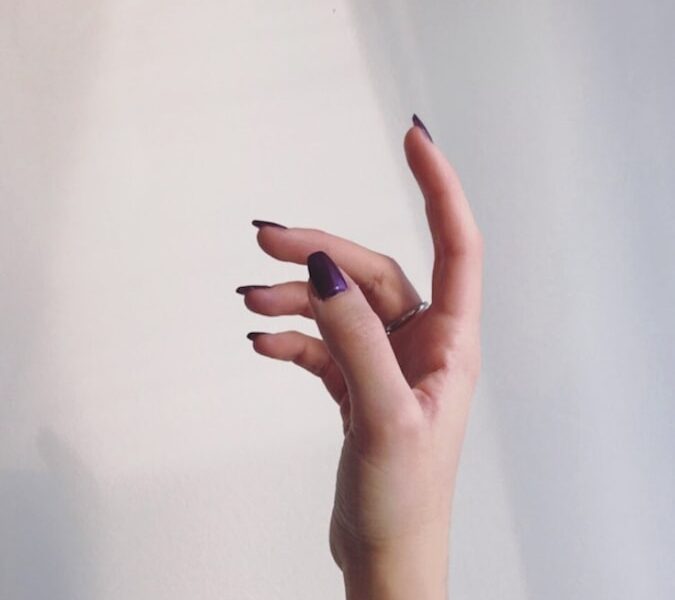 persons left hand on white wall