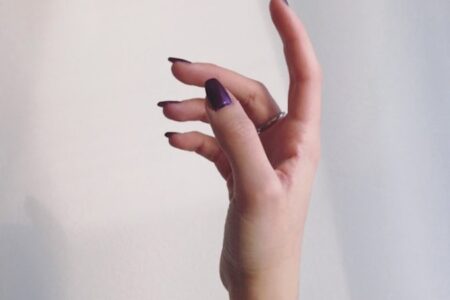 persons left hand on white wall