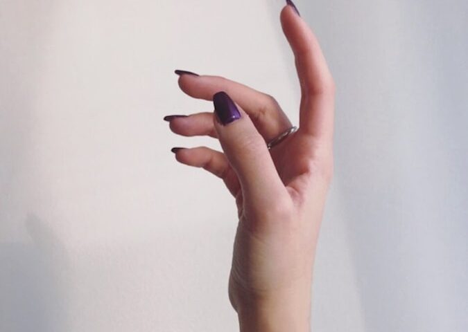 persons left hand on white wall